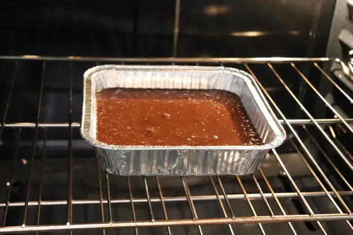 A chocolate cake in an oven.